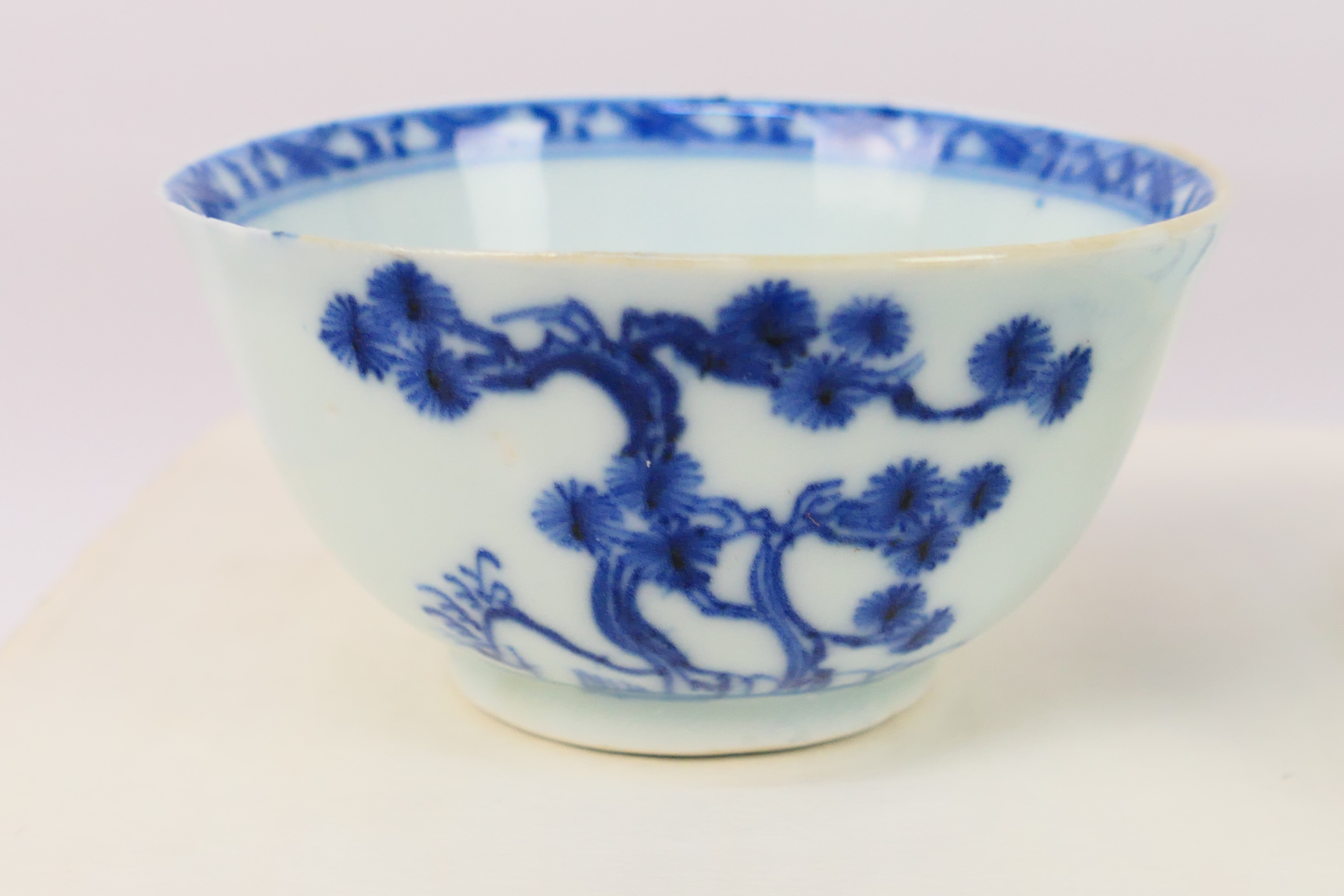 Nanking Cargo - A Qing dynasty blue and white tea bowl and saucer decorated with pine trees, c. - Image 5 of 9