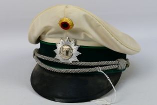 A white German presumed police hat by Pekuro. The hat is marked Peter Kupper.