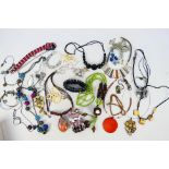 A collection of costume jewellery comprising necklaces and bracelets.