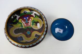 A Chinese cloisonne bowl, the exterior with confronting dragons and flaming pearl,