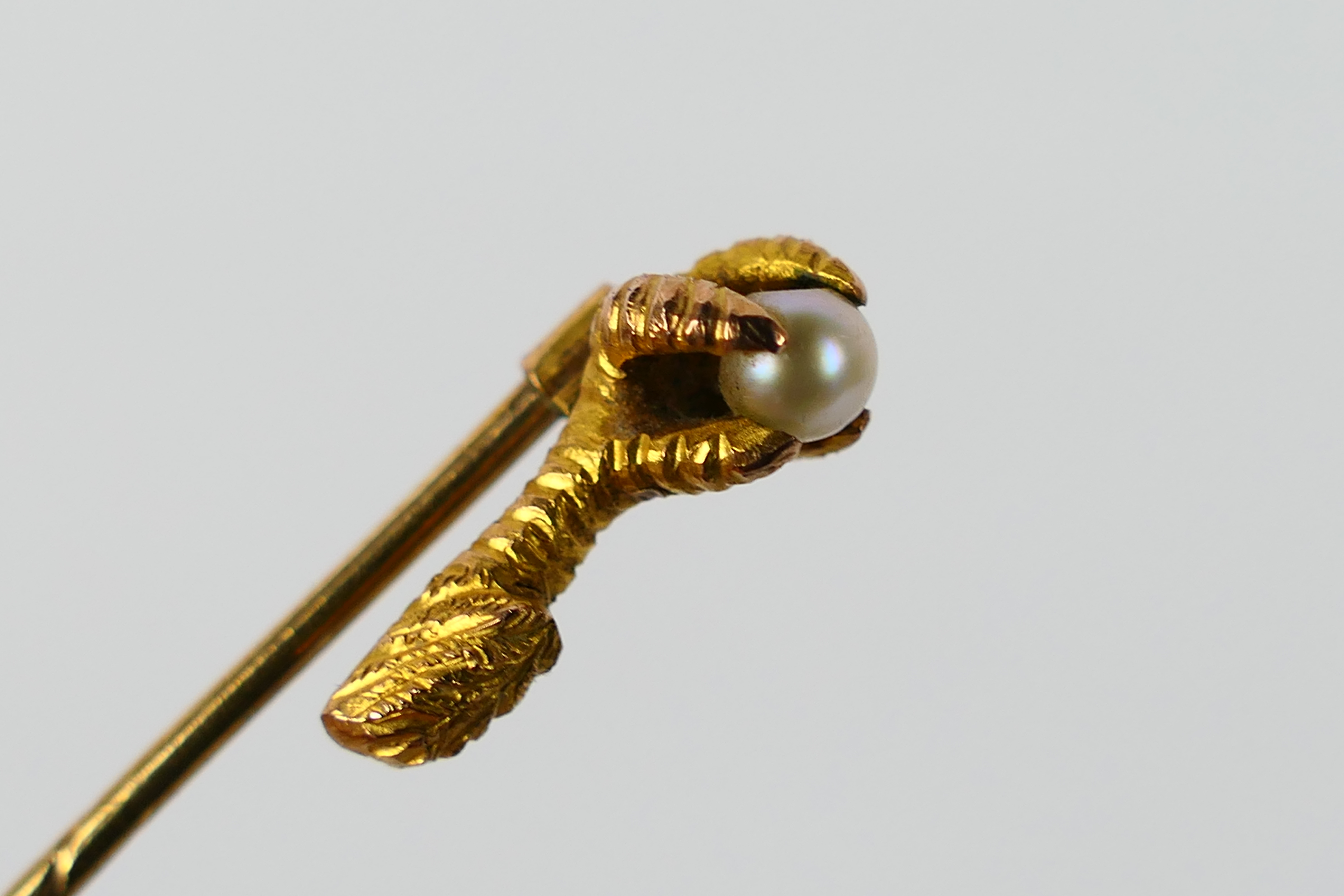 A Victorian yellow metal and pearl stick pin, formed as a bird's talon clutching the pearl, - Image 5 of 9