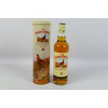 A 70cl bottle of Famous Grouse whisky, 40% abv, contained in presentation tin.
