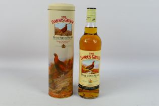 A 70cl bottle of Famous Grouse whisky, 40% abv, contained in presentation tin.