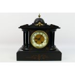 A mantel clock of architectural form, Arabic numerals to a 4" dial, approximately 32 cm (h),