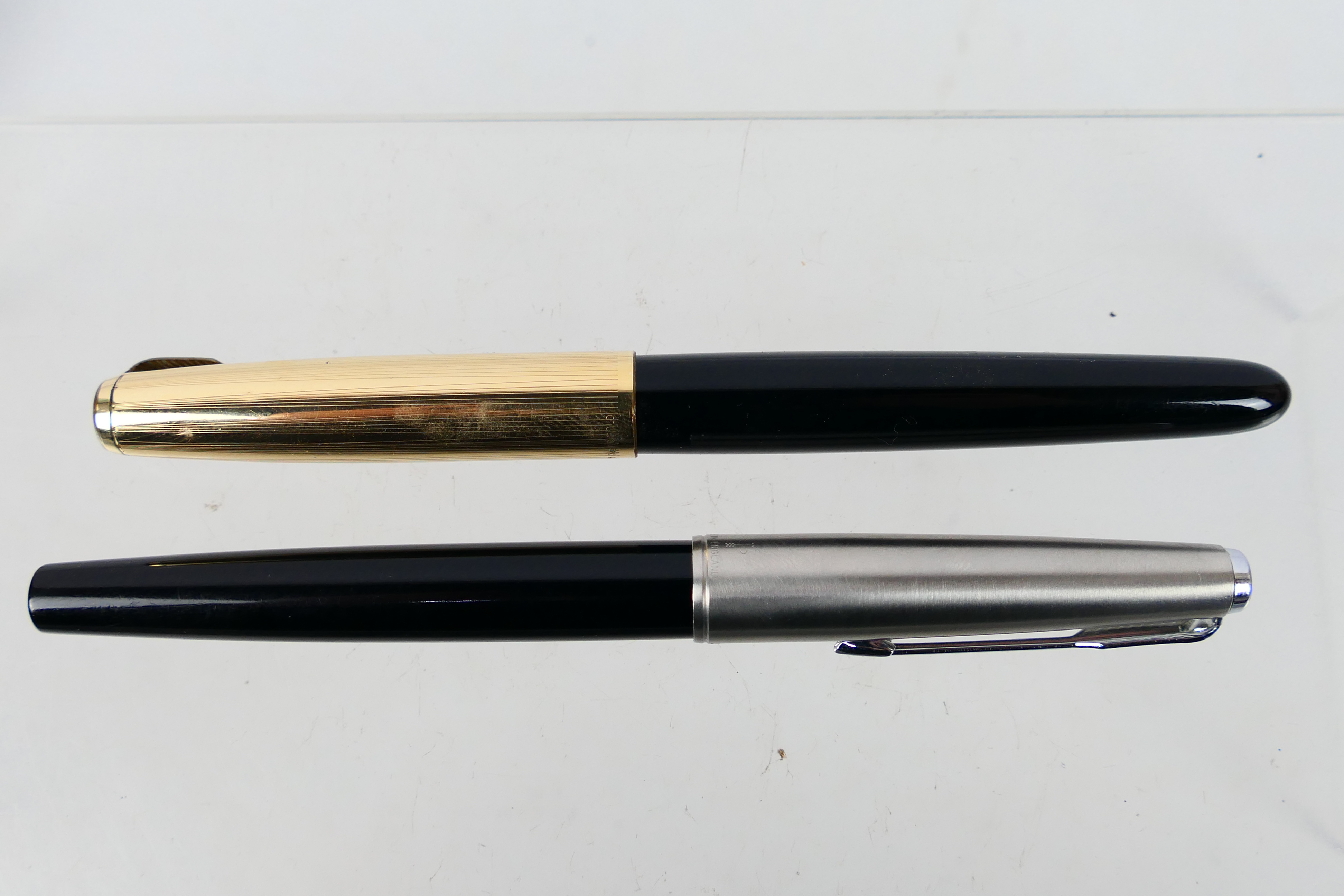 Two Parker fountain pens to include a Parker 51 with service receipt.