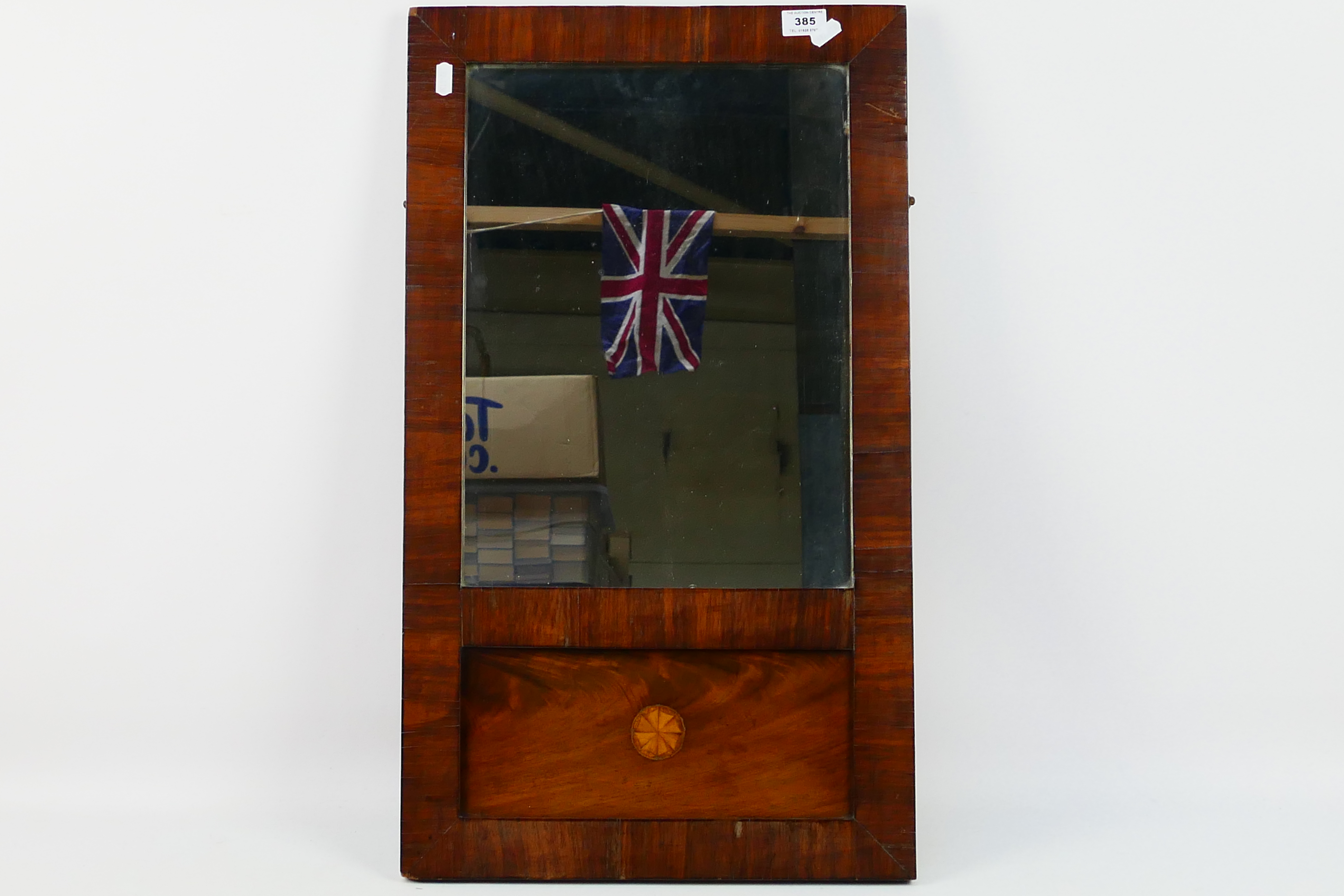 An Edwardian mahogany framed wall mirror with inlaid decoration, approximately 68 cm x 39 cm.