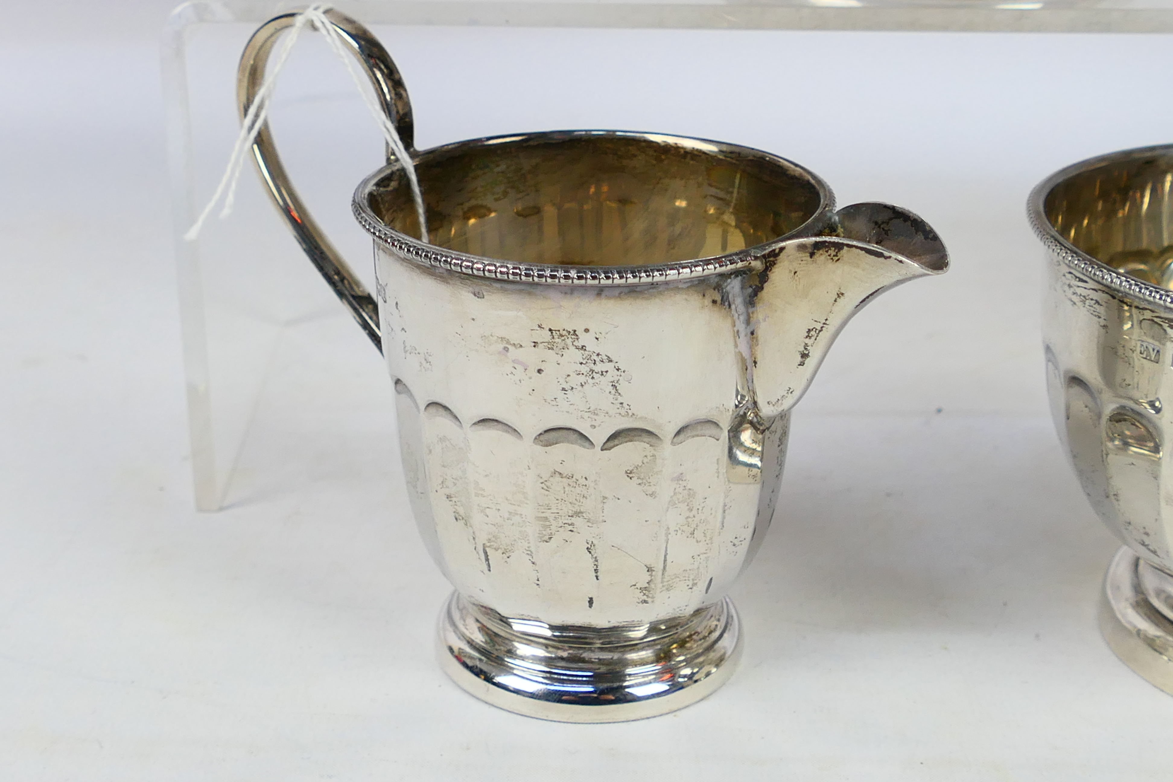 A silver tea service comprising teapot, sugar bowl and milk jug, Sheffield assay 1936, - Image 5 of 8