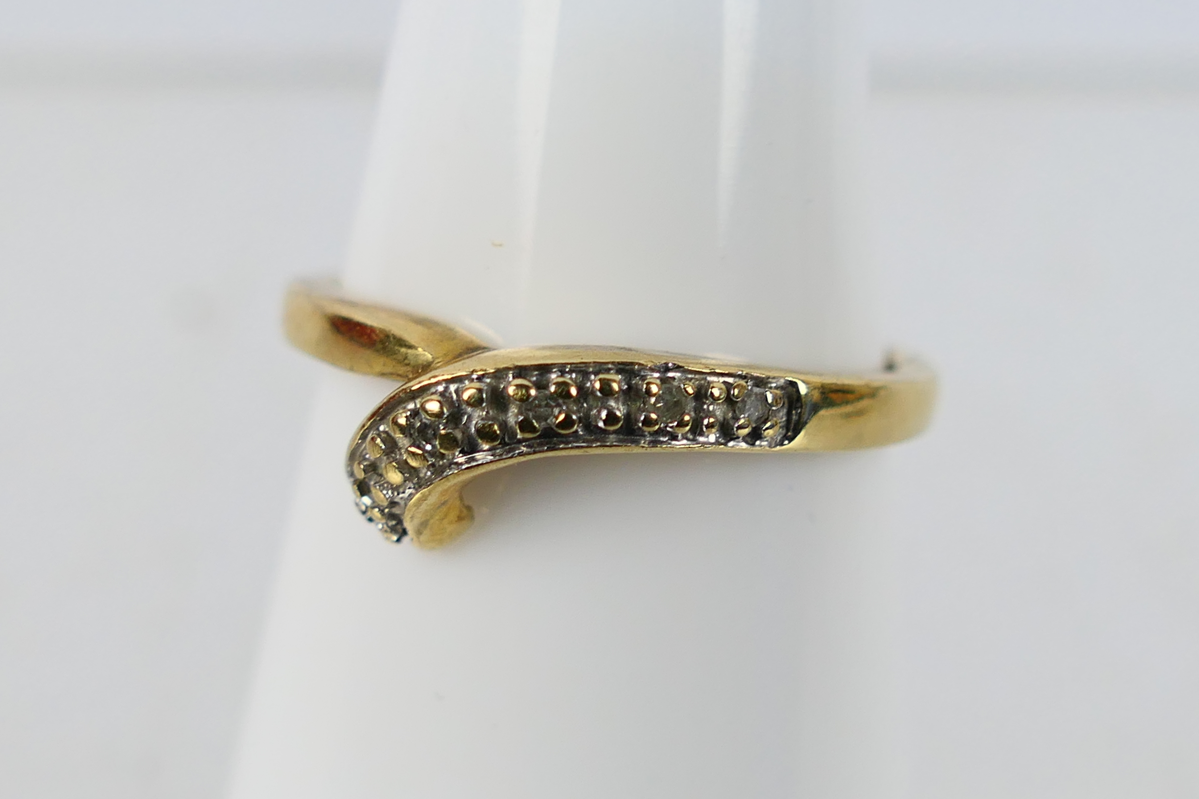 A pair of 9ct yellow gold rings set with diamond chips, size O, approximately 4.9 grams. - Image 3 of 4