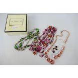 Three decorative costume jewellery necklaces and a pair of earrings.