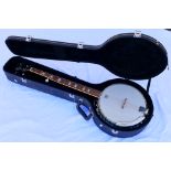 A Westfield five string banjo with Remo Weather King head, contained in hard case with accessories.