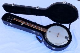 A Westfield five string banjo with Remo Weather King head, contained in hard case with accessories.