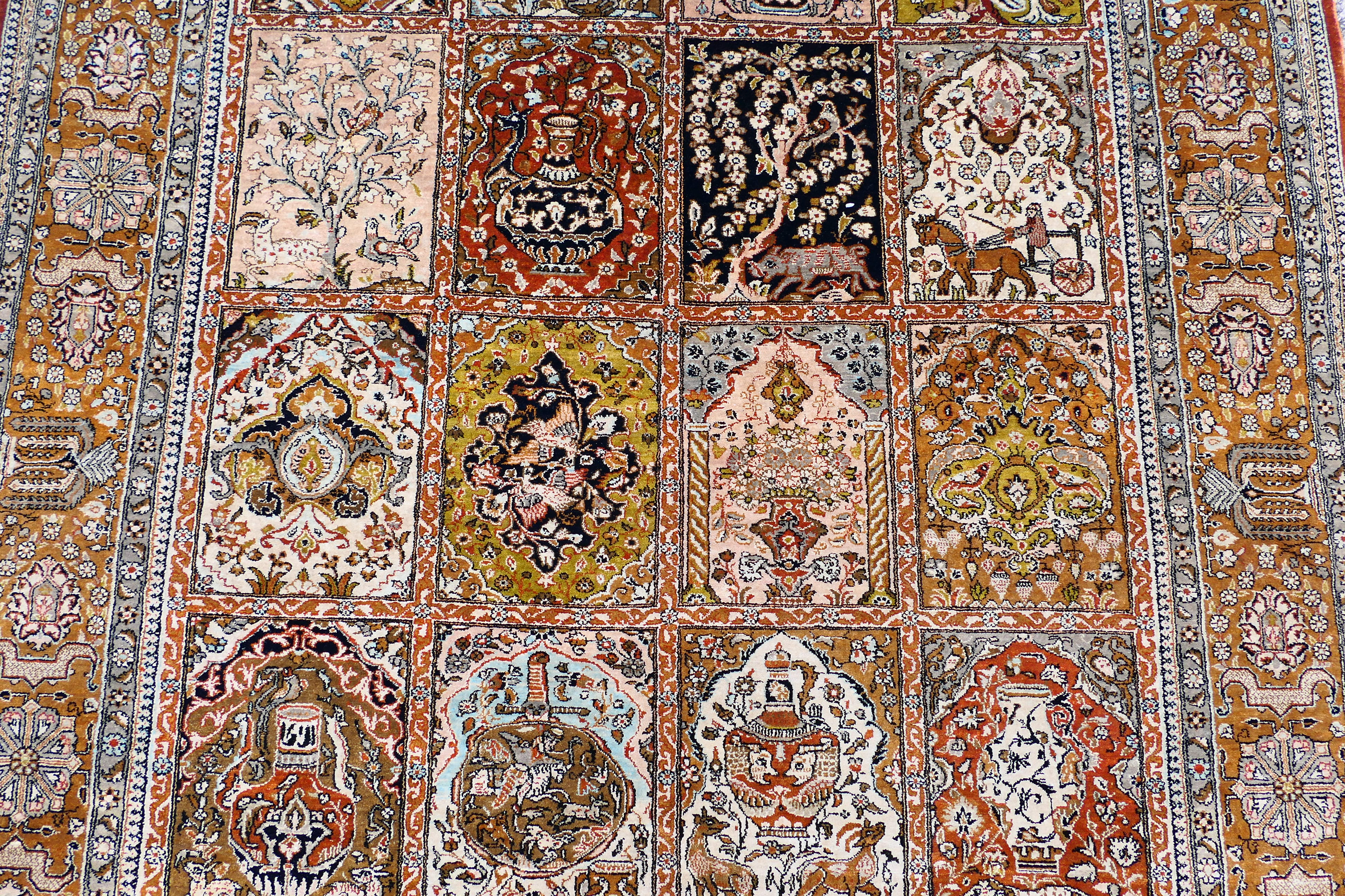 A Persian rug decorated with panels of flowering urns, - Image 3 of 17