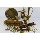 A collection of Asian metal wares to include ewers, Benares table, dishes and other.