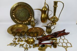 A collection of Asian metal wares to include ewers, Benares table, dishes and other.