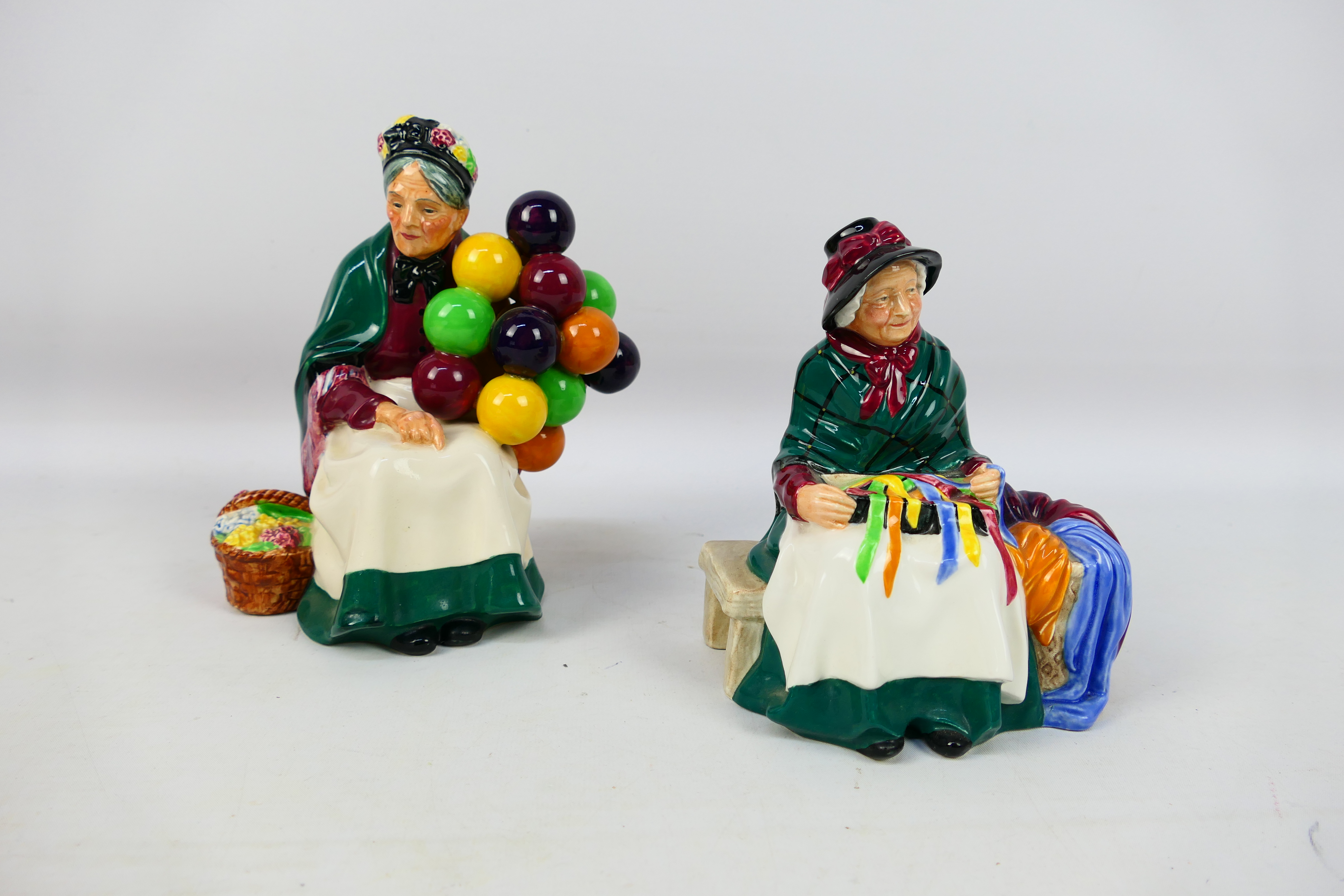 Two Royal Doulton figures comprising # HN1315 The Old Balloon Seller and # HN2017 Silks And Ribbons,