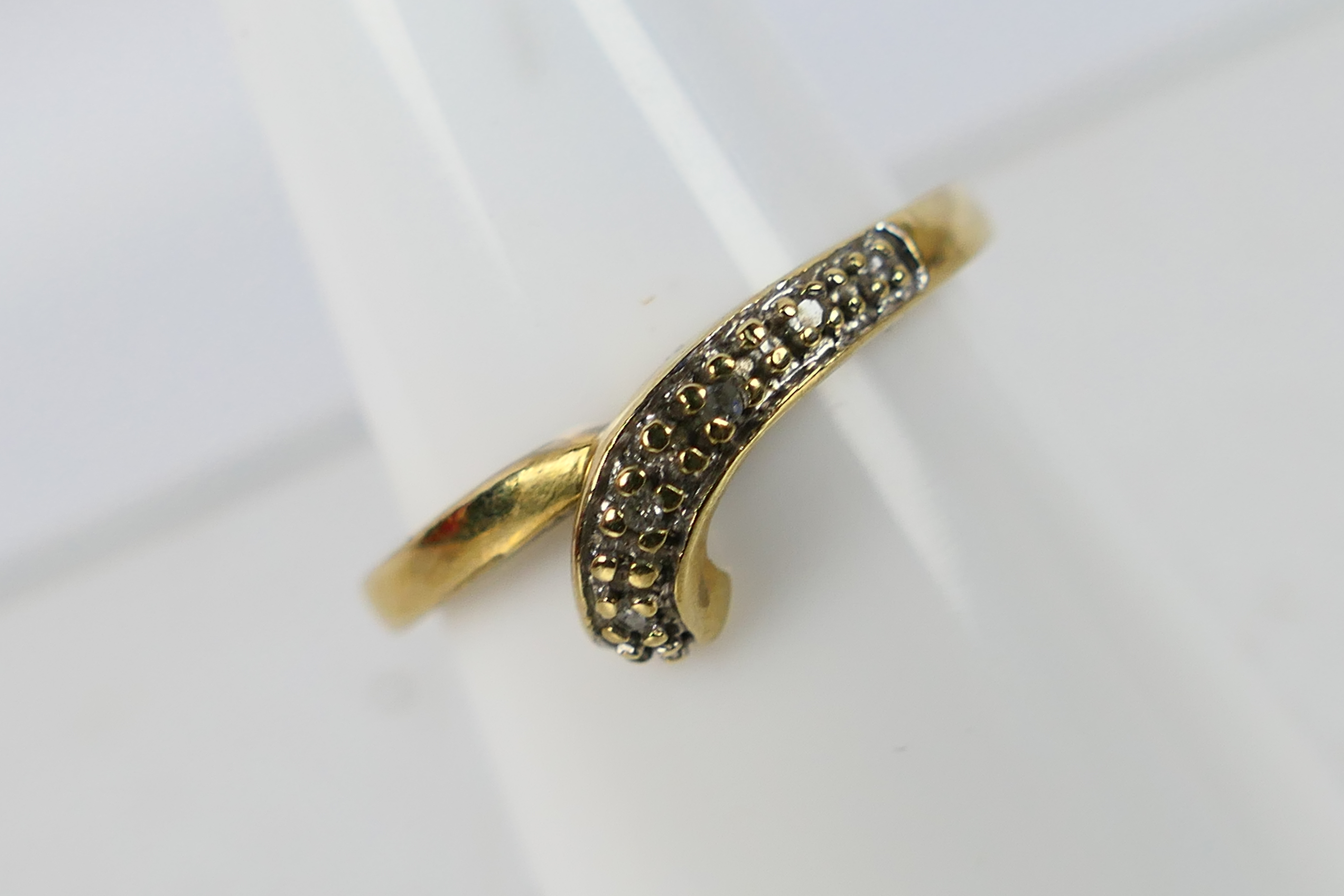 A pair of 9ct yellow gold rings set with diamond chips, size O, approximately 4.9 grams. - Image 2 of 4