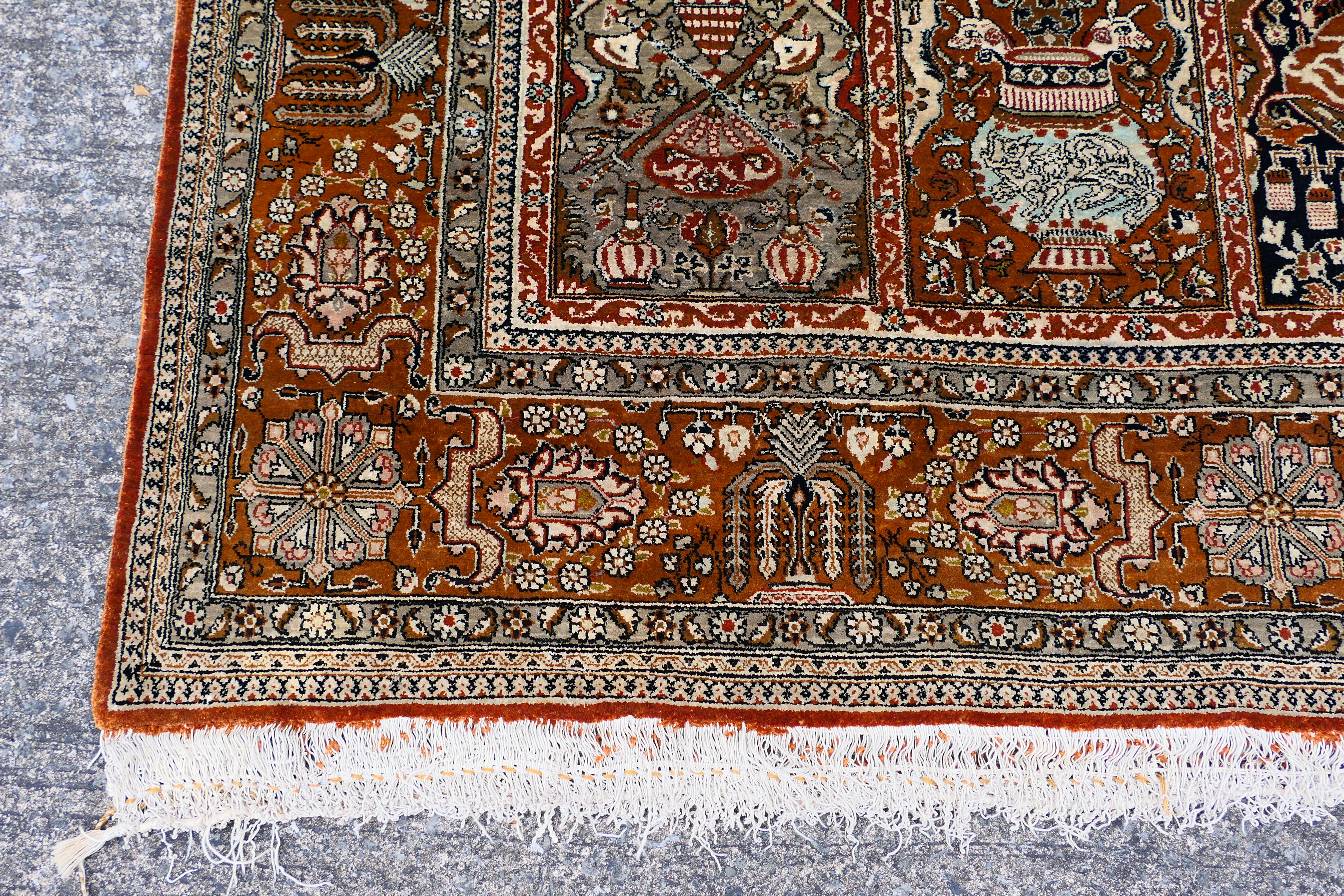 A Persian rug decorated with panels of flowering urns, - Image 8 of 17