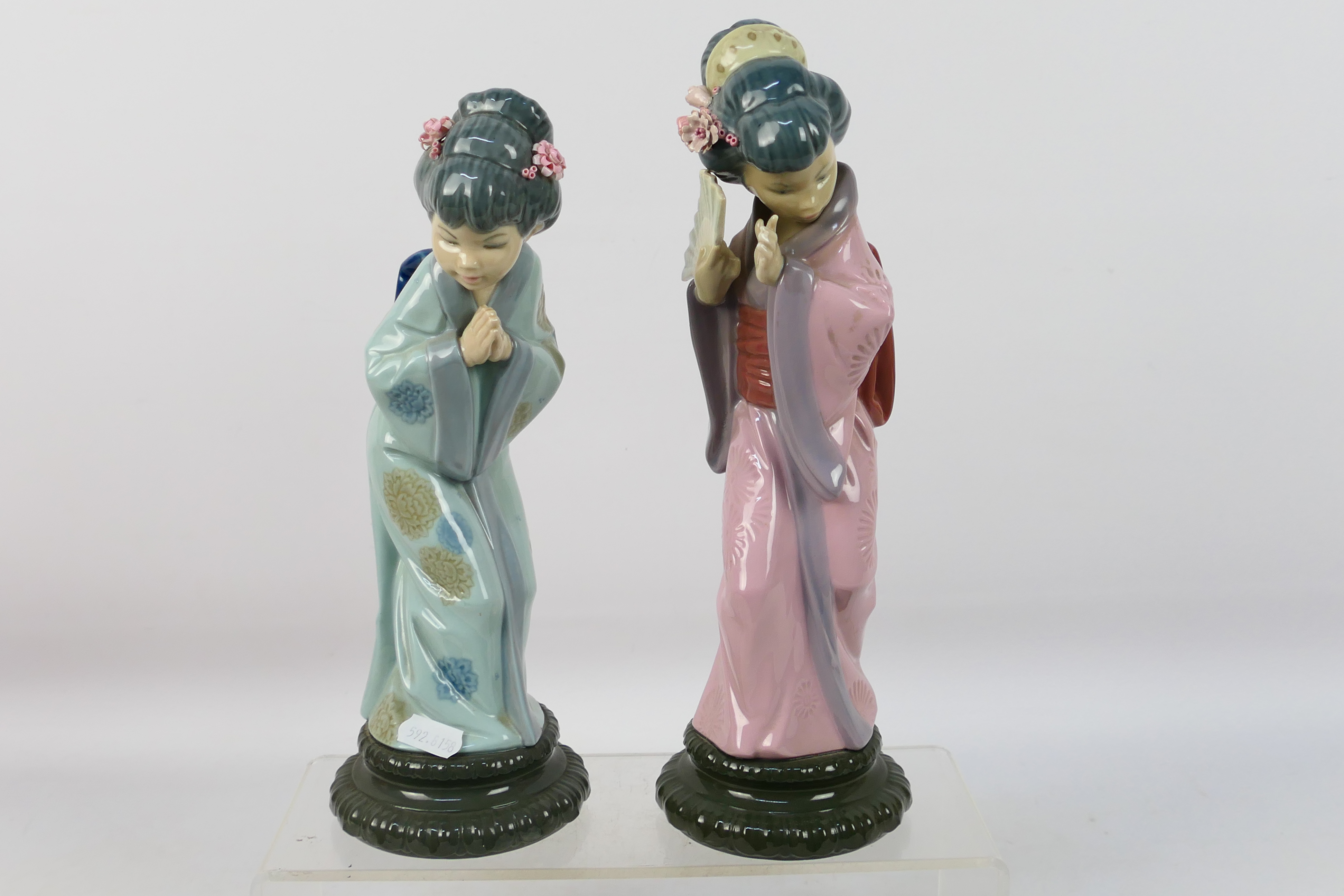 Two Lladro figures depicting Japanese ladies comprising # 4990 Chrysanthemum and # 4989, Sayonara,