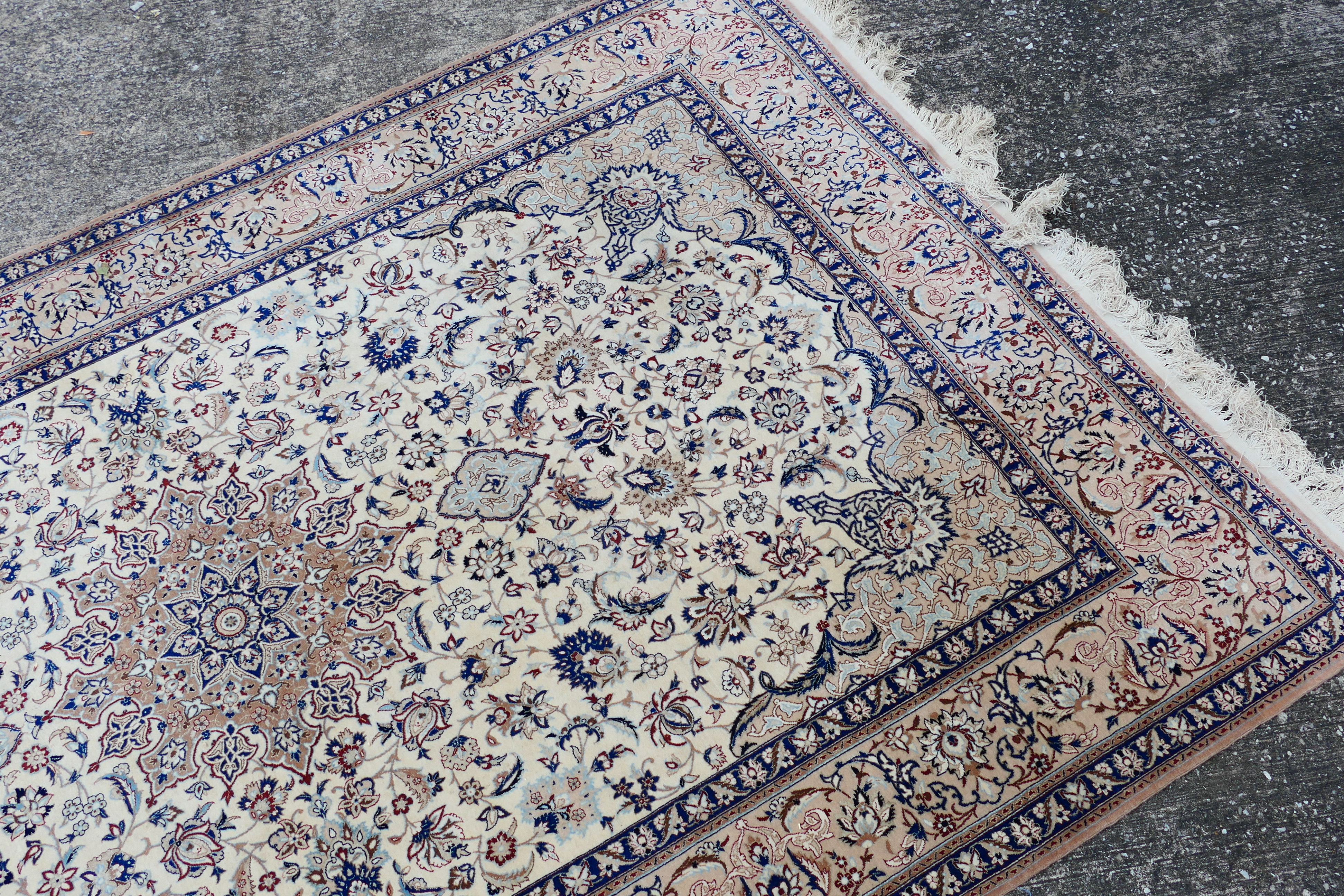 A Persian ivory ground rug with central medallion on a floral field, with foliage scroll border, - Image 4 of 14