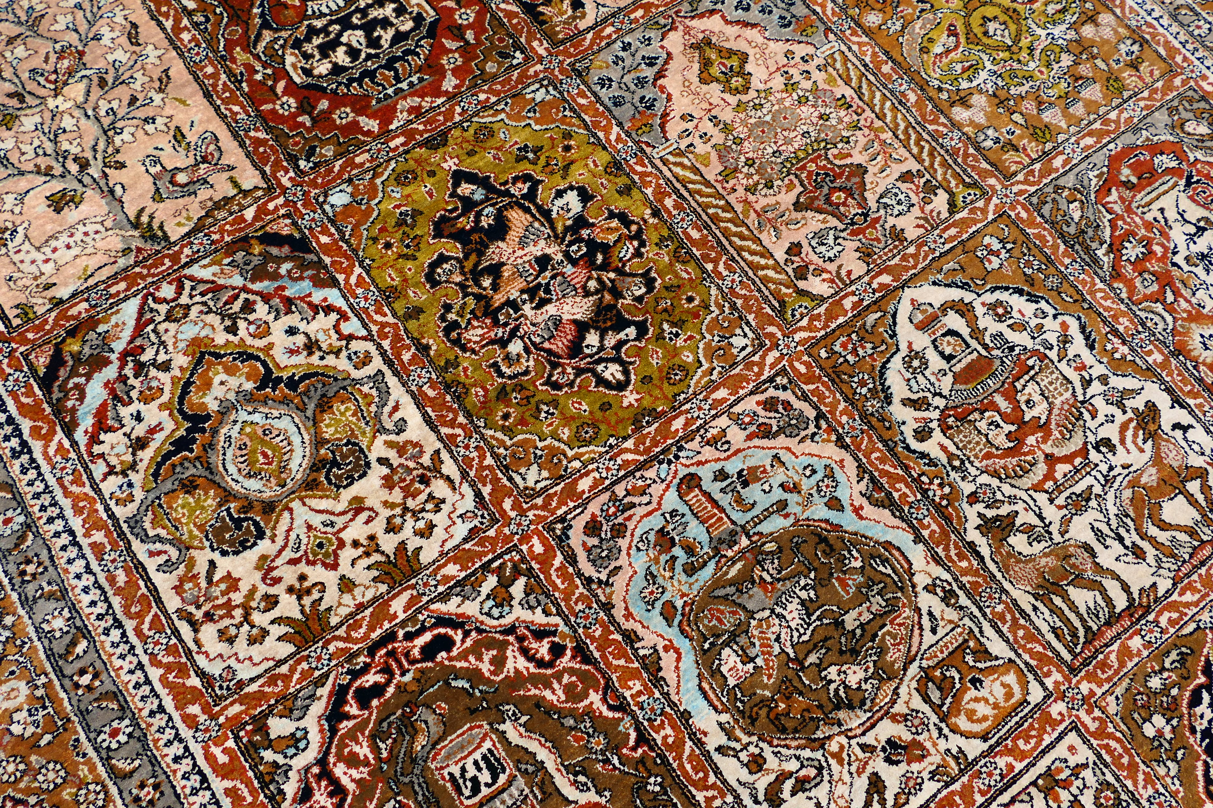 A Persian rug decorated with panels of flowering urns, - Image 13 of 17