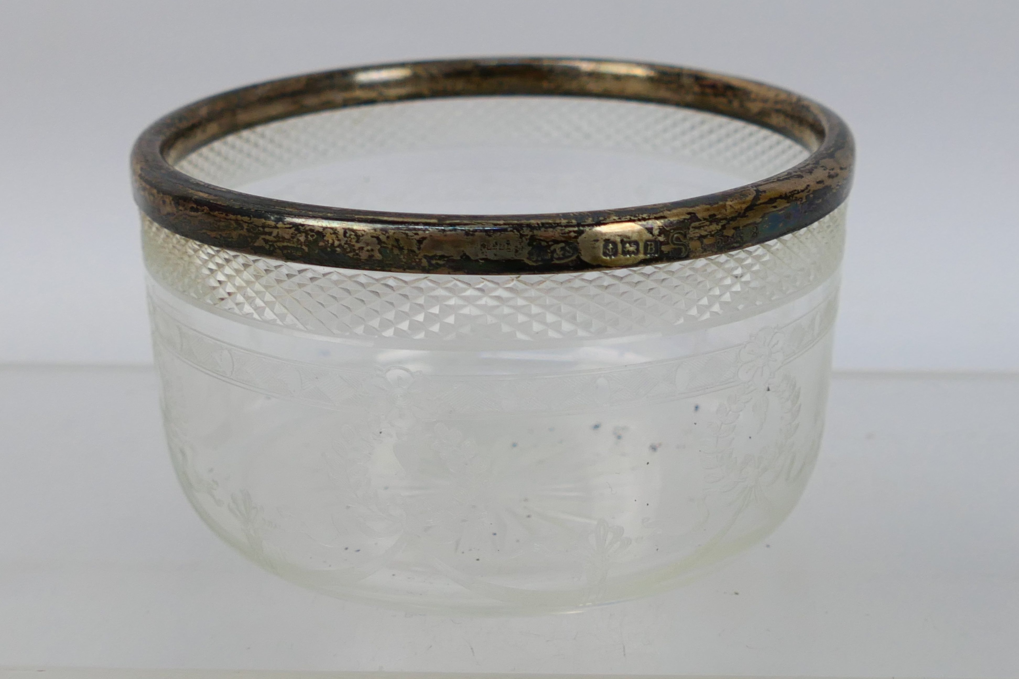 A small crystal glass bowl with sterling silver rim. Makers marked J.G and S. 5 cm (h).