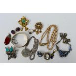 A collection of vintage costume jewellery to include a silver hinged bangle and silver pendant and