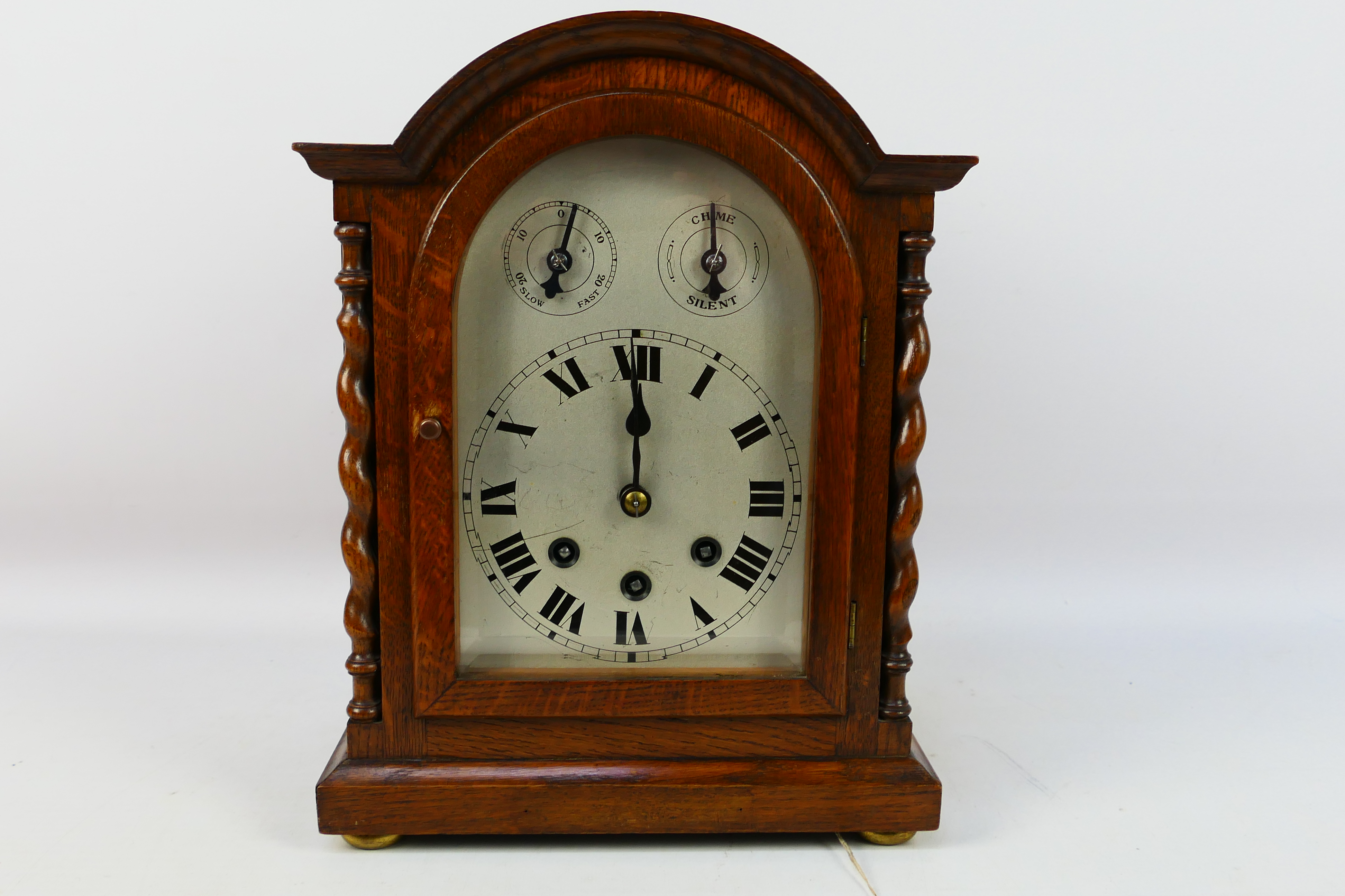 An early 20th century oak cased Westminster chiming mantel clock, the case of a medium oak colour,