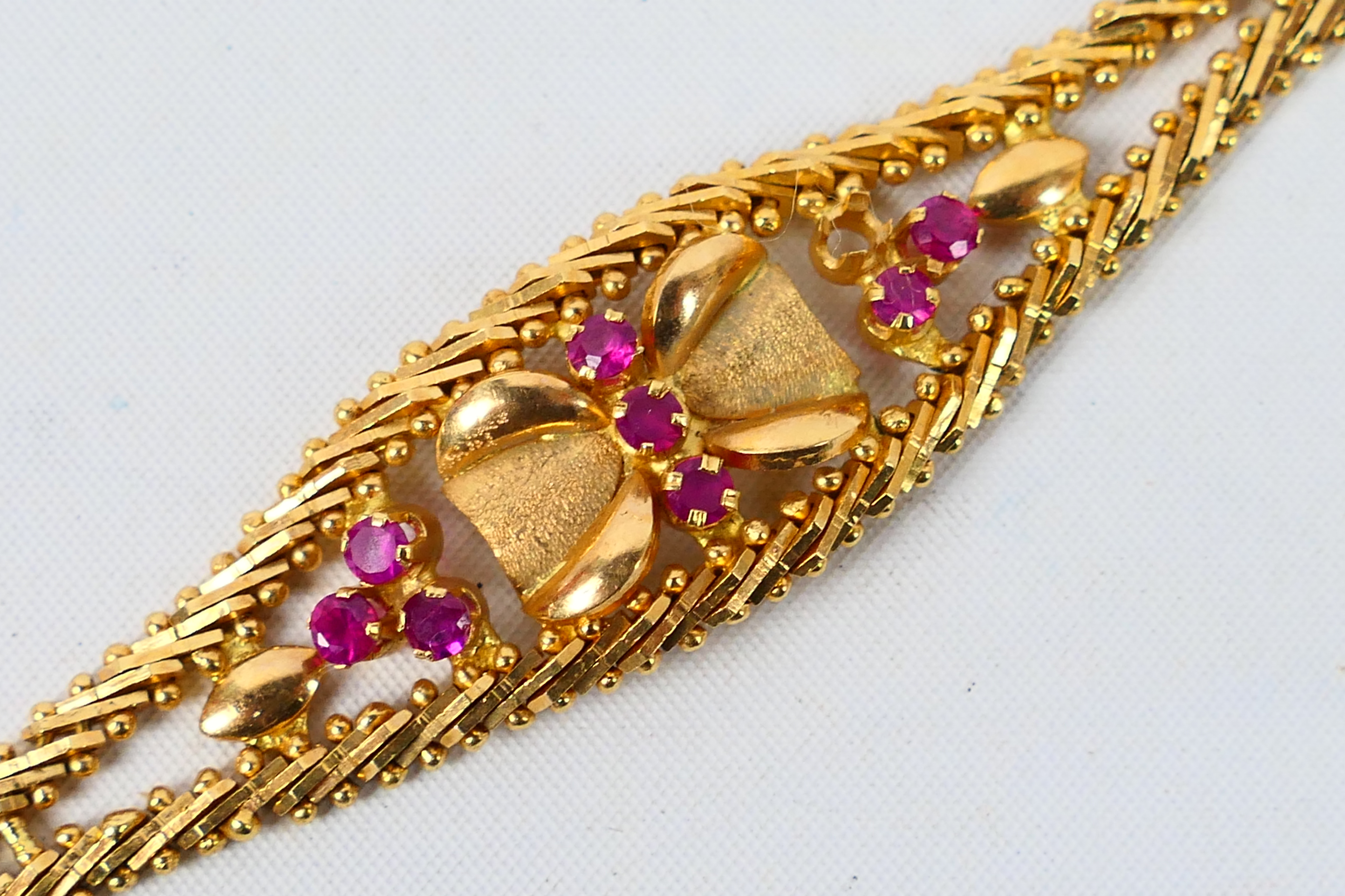 A yellow metal bracelet set with rubies (one stone lacking), stamped 750 and assessed as 18ct, - Image 2 of 6