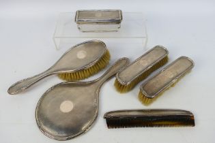 A George V silver mounted six piece dressing table set with engine turned decoration,