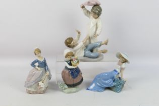 A collection of Lladro and Nao figures / groups, largest approximately 24 cm (h).
