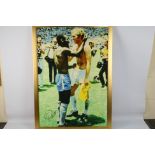 A Reproduction Canvas Print of Pele and Bobby Moore, hand signed by Pele, framed, 88cm by 61cm,