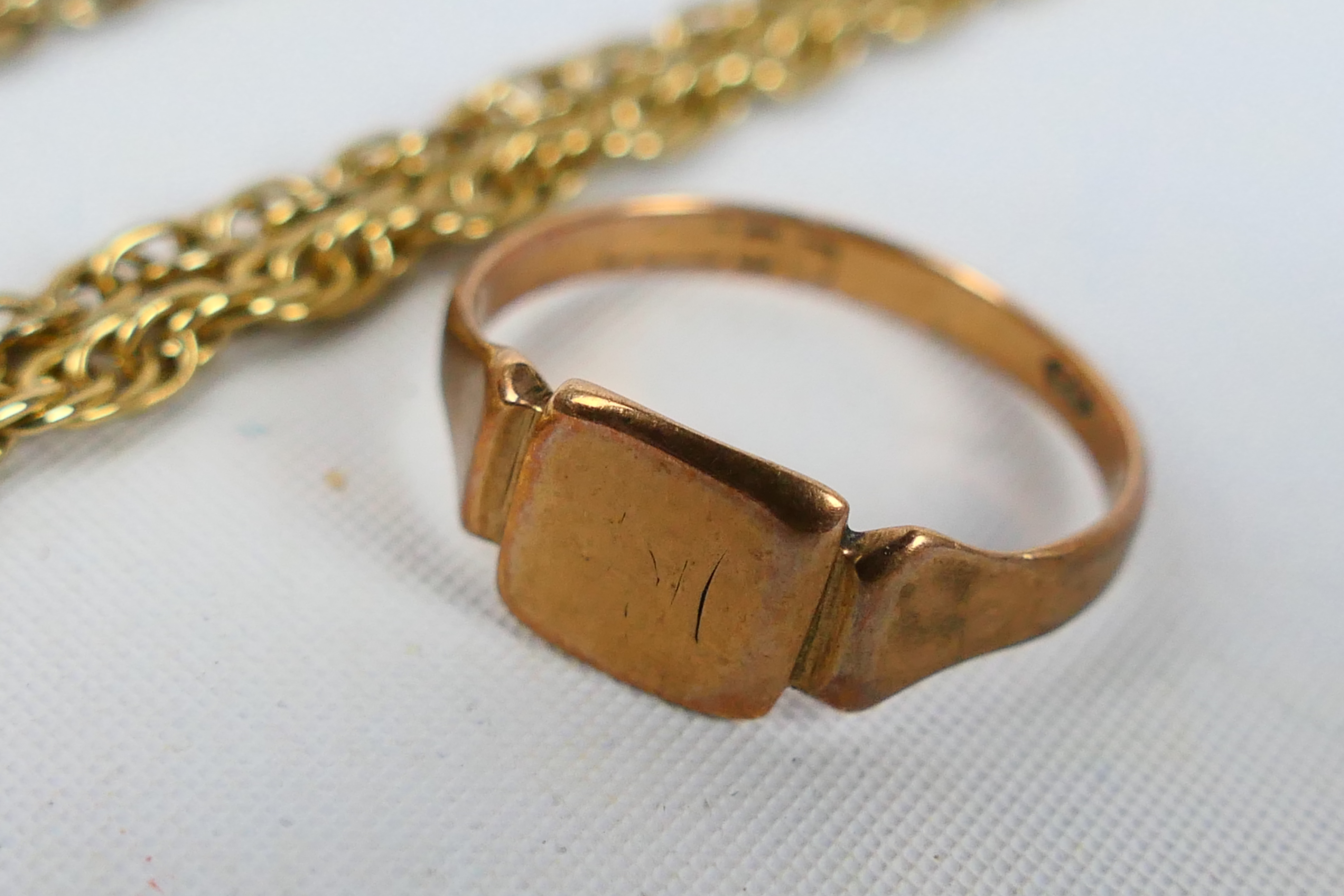 A rose gold ring (hallmarks very rubbed but presumed 9ct) and an unmarked yellow metal chain, - Image 4 of 5