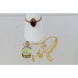 A 9ct yellow gold stone set pendant on chain stamped 10k, 46 cm (l) and a 9ct rose gold ring,