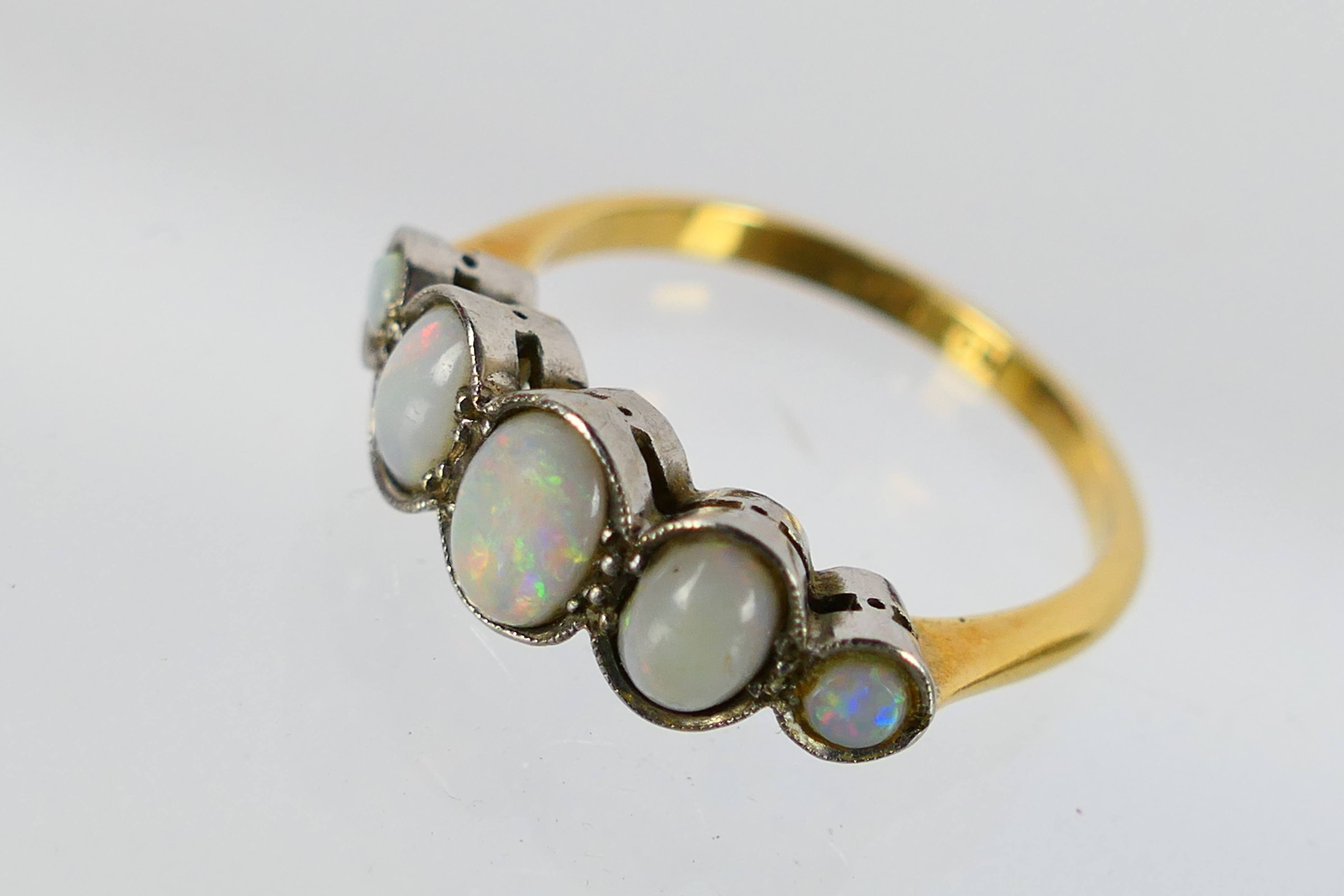 A five stone opal ring, stamped 18ct PLAT, size N+½, 3.2 grams. - Image 4 of 6