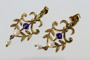 A pair of 9ct yellow gold drop earrings set with seed pearl and purple stones, approximately 2.
