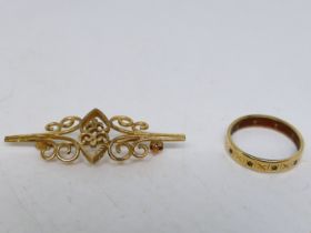 A 9ct yellow gold openwork brooch and a yellow metal, stone set ring, stamped 9ct, size M,