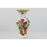 A small Chelsea style vase decorated with exotic bird and flowers, gold anchor mark to the base,