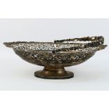 An Edward VII silver fruit bowl with embossed and pierced floral scroll decoration, swing handle,