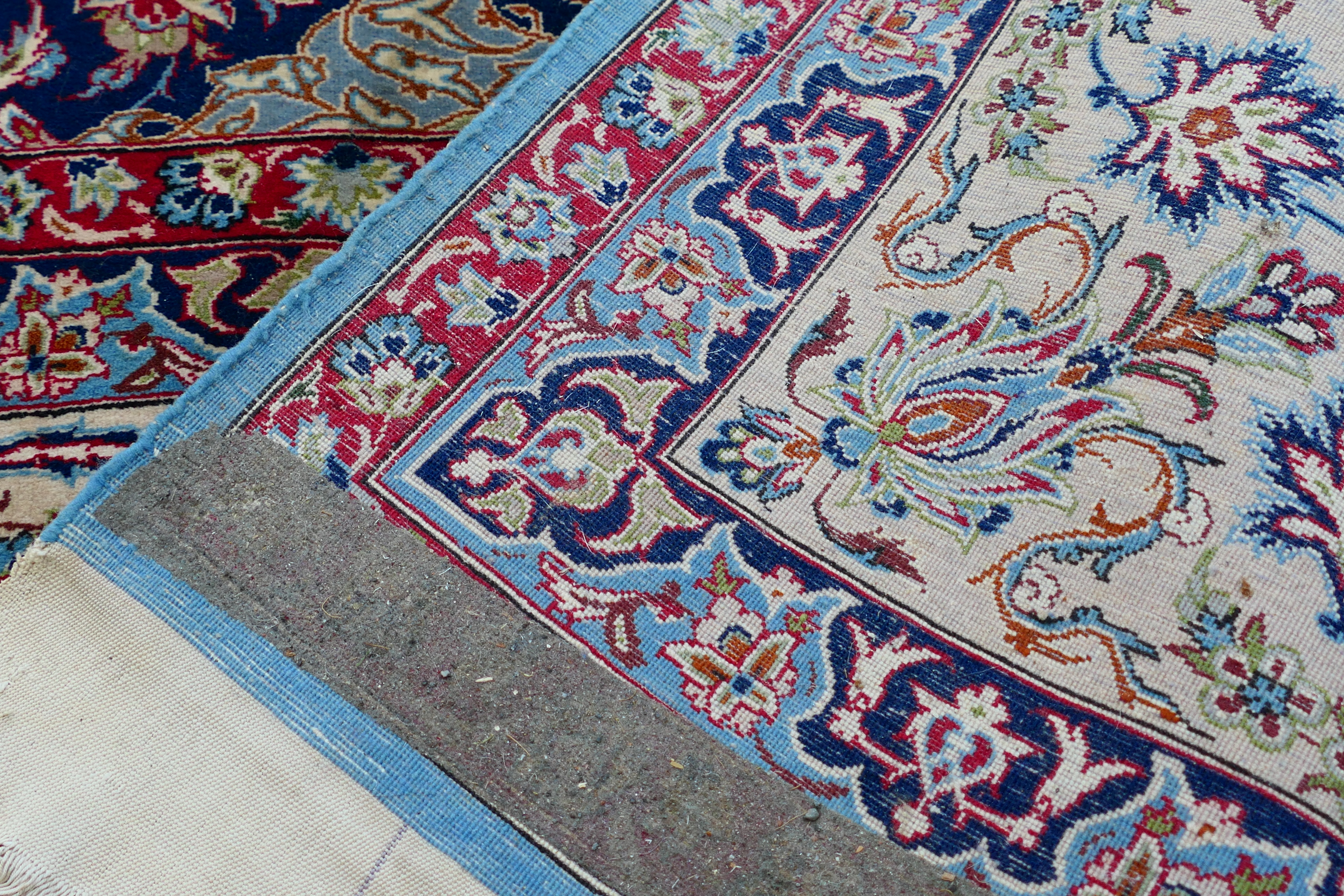 A signed Persian ivory ground rug with central floral medallion, - Image 7 of 7