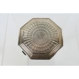 A silver powder compact of octagonal form having engine turned decoration to the cover,