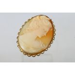 A yellow metal cameo brooch, stamped 9ct, 5 cm (l), with profile portrait of a lady,