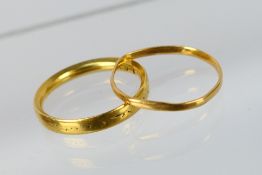 A 22ct gold band ring (misshapen) and one further ring marked with makers mark, size N,