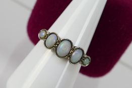 A five stone opal ring, stamped 18ct PLAT, size N+½, 3.2 grams.