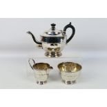 A silver tea service comprising teapot, sugar bowl and milk jug, Sheffield assay 1936,