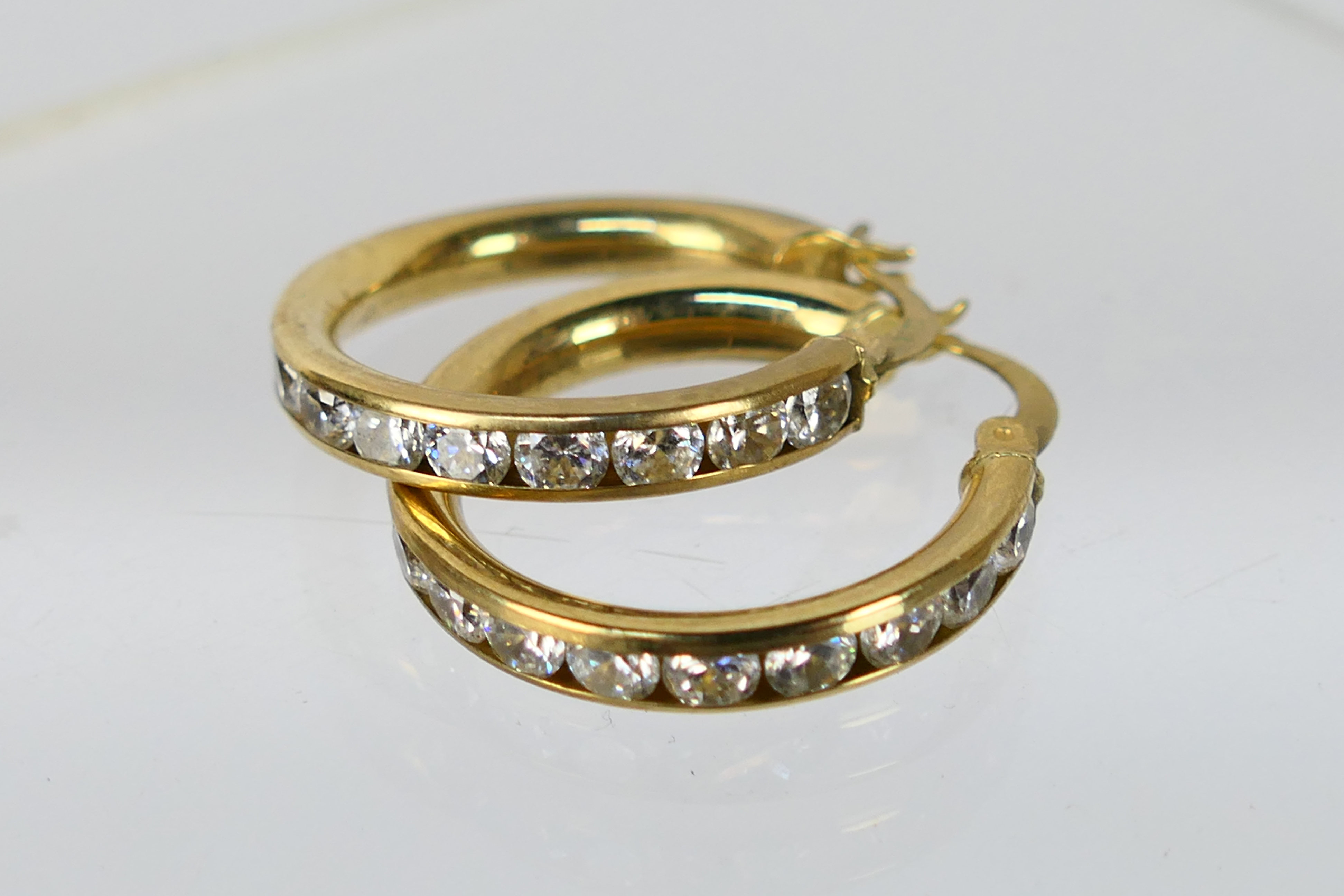 A pair of 9ct yellow gold, stone set ear hoops, approximately 3.7 grams. - Image 2 of 4