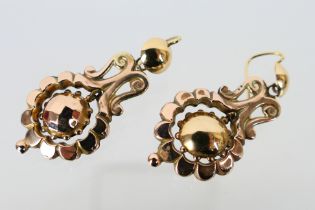 A pair of rose metal drop earrings, assessed as 9ct, approximately 6 grams.
