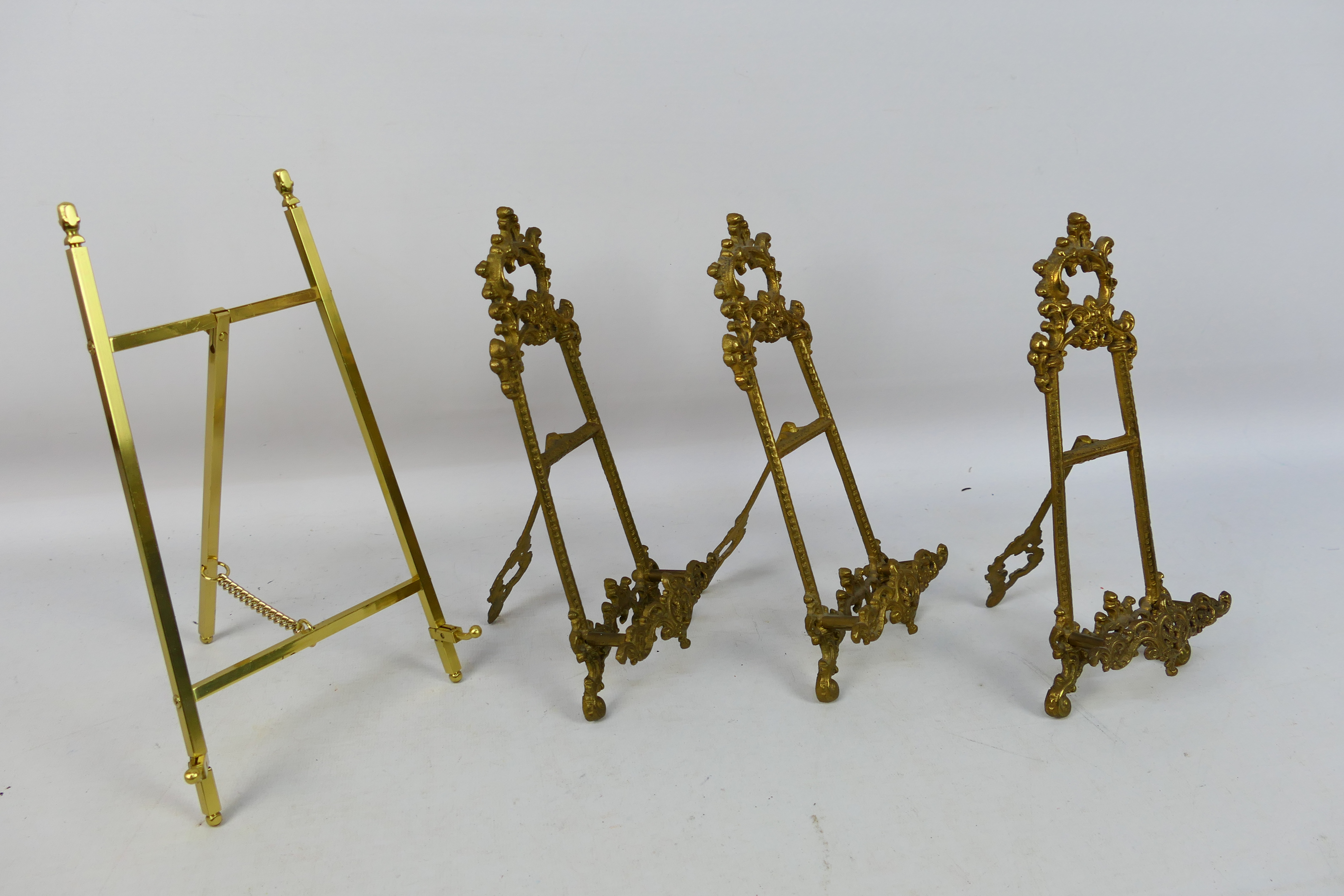 Three cast brass, easel plate stands and one similar. - Image 2 of 2