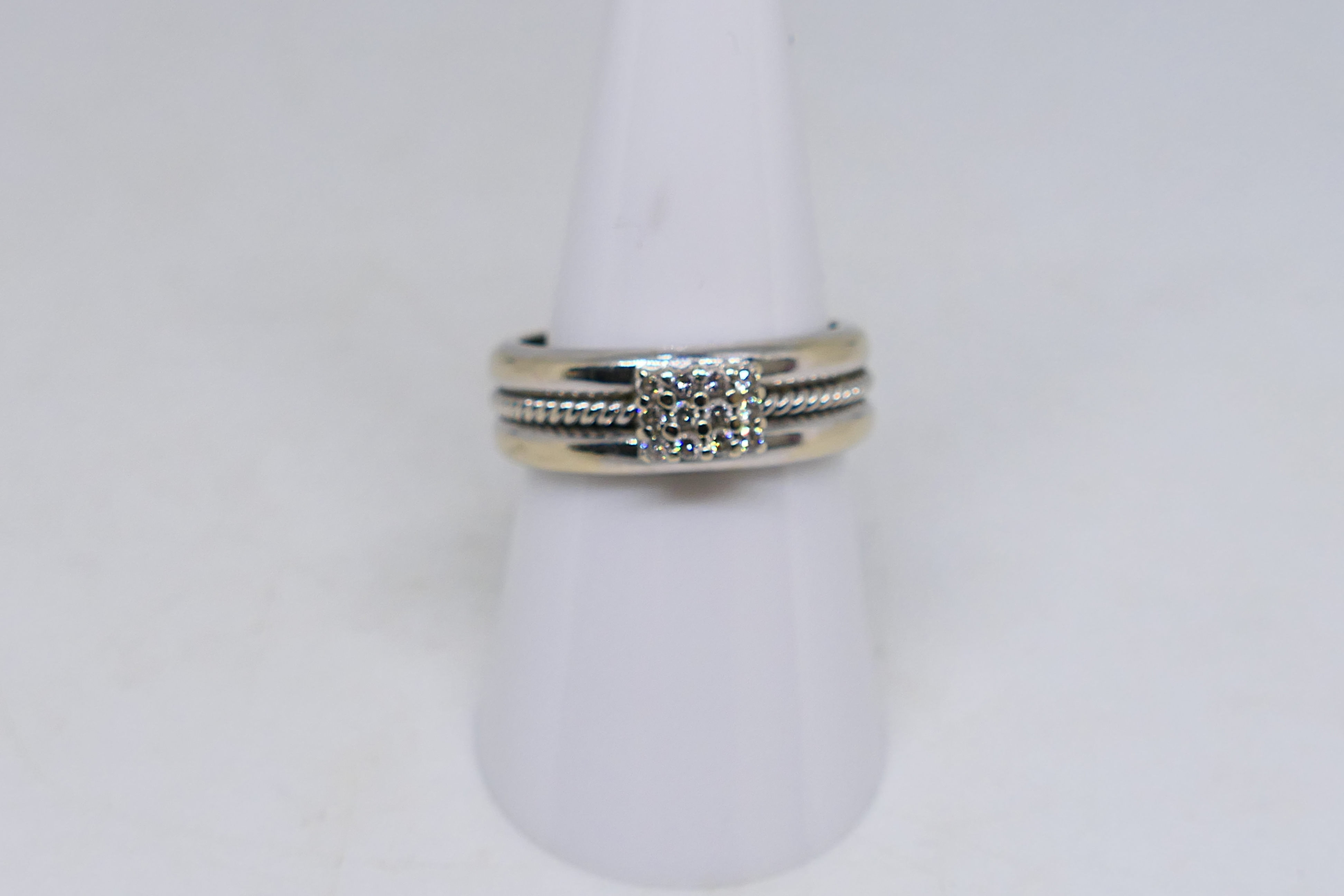 A white metal ring (assessed as 9ct) set with twelve small diamonds, size P, approximately 7. - Image 5 of 6