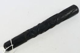 An Irish bog oak truncheon, carved with harp and shamrocks, approximately 24 cm (l).