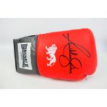 Boxing Interest - A red Lonsdale boxing glove signed by Anthony Joshua,